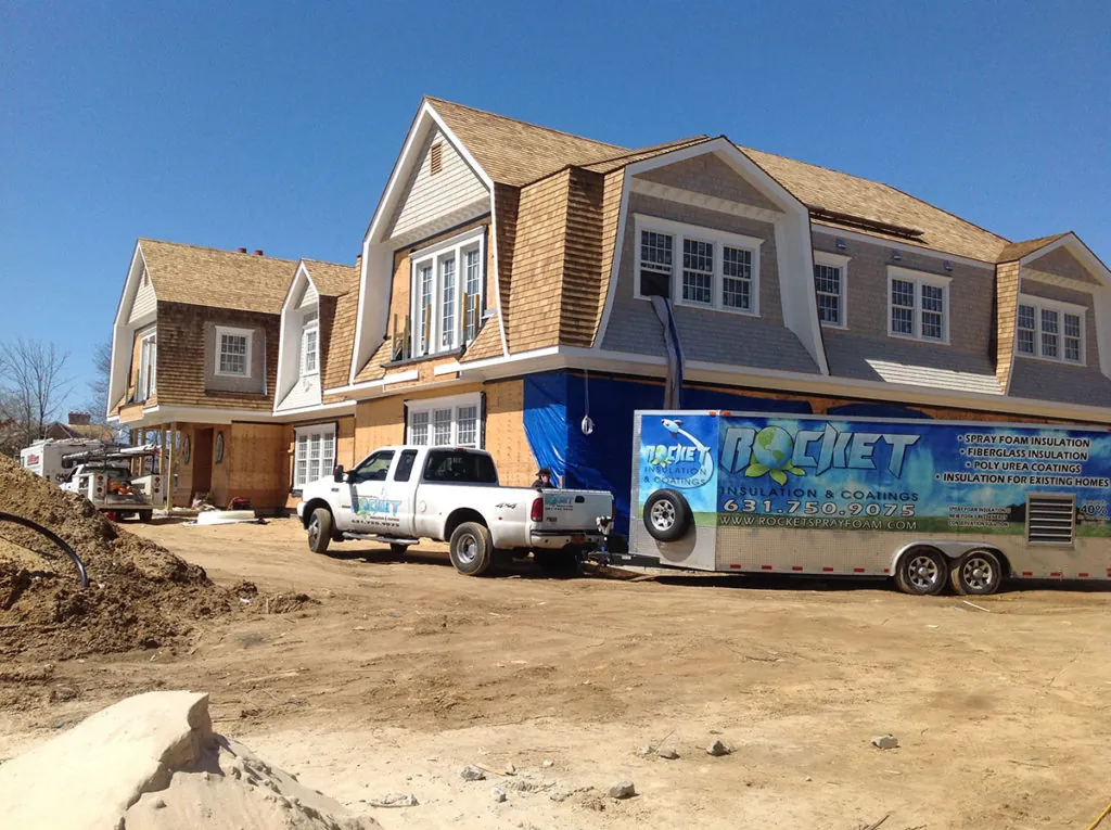 Rocket Insulation van parked outside of new construction home
